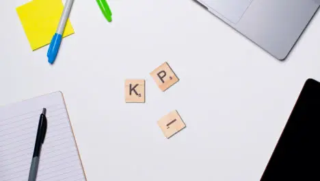 Stop Motion Business Concept Above Desk Wooden Letter Tiles Forming Acronym KPI