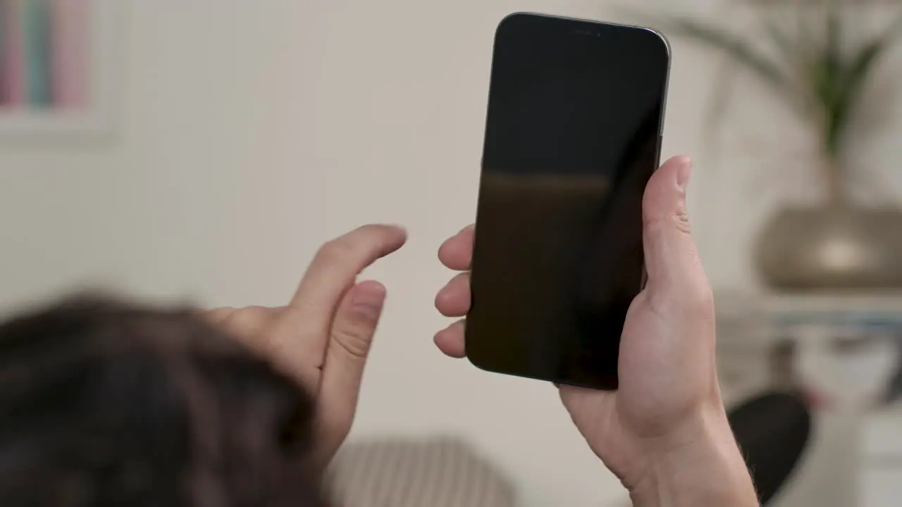 Man Holding Mobilephone Swipe Screen From Right To Left