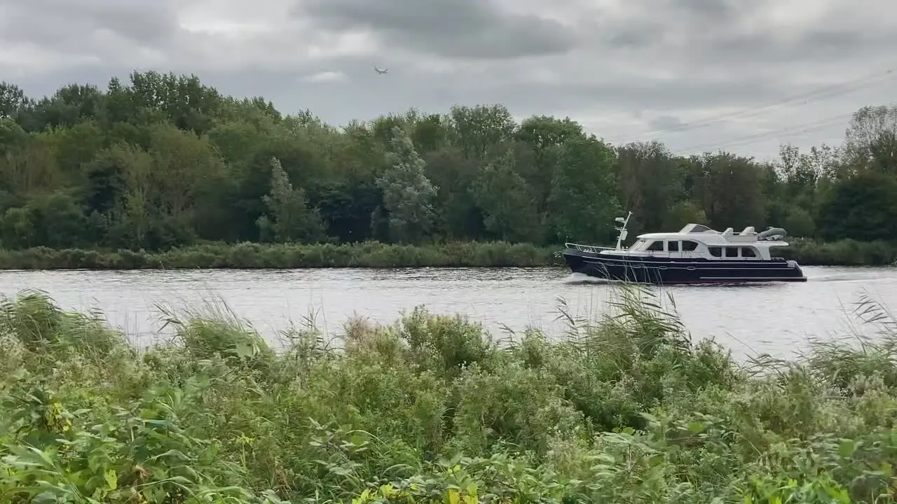 A leisure ship passing by on a canal in Holland