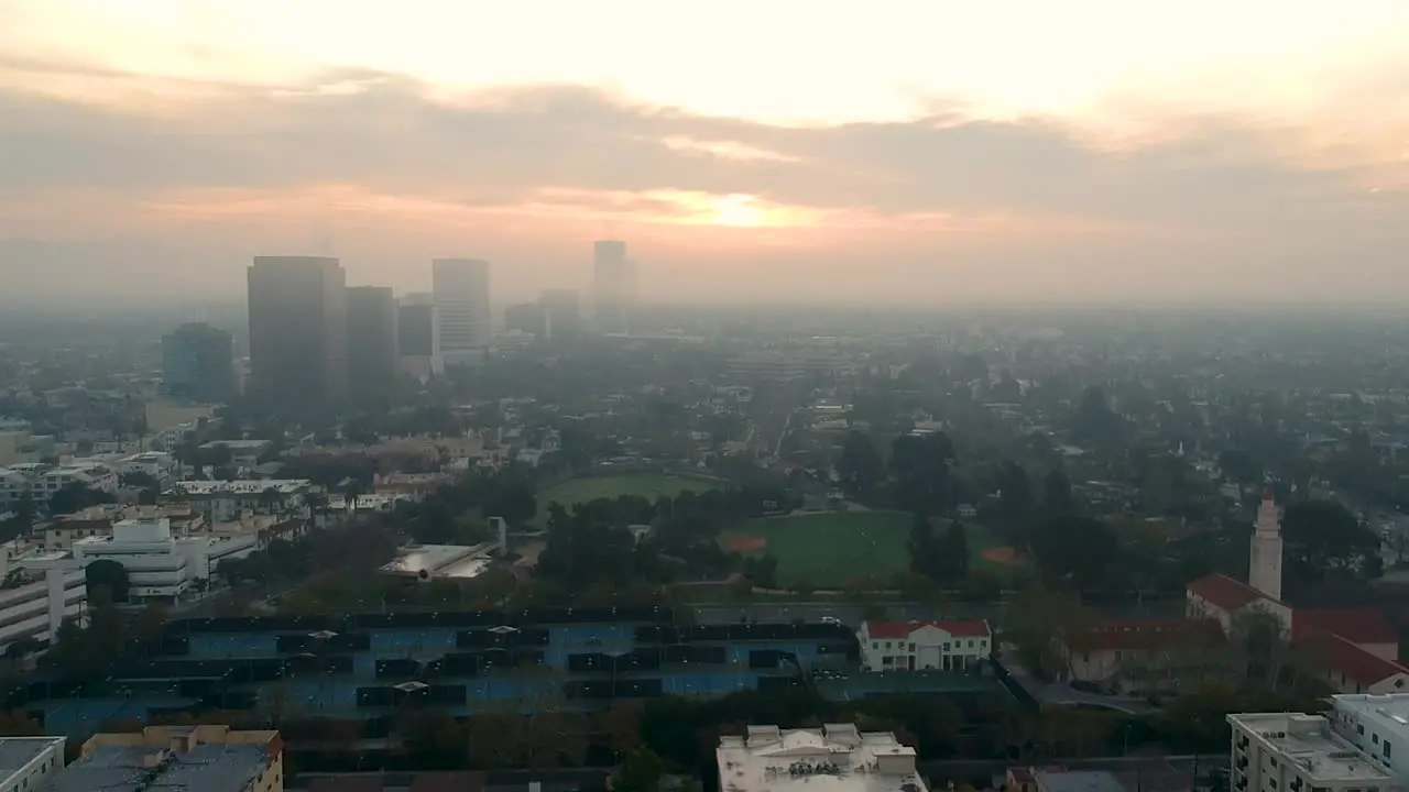 Aerial pan down in foggy Los Angeles on a cloudy early morning