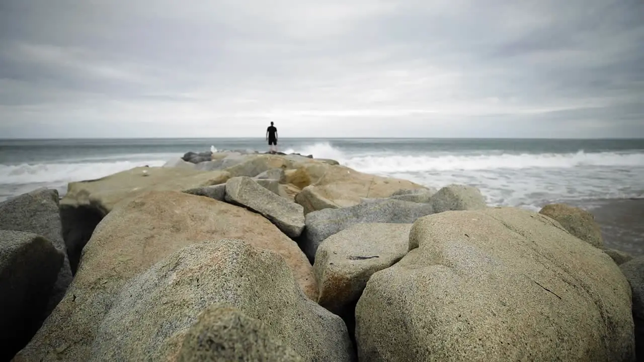 Man standing on jetty at Santa Monica State Beach