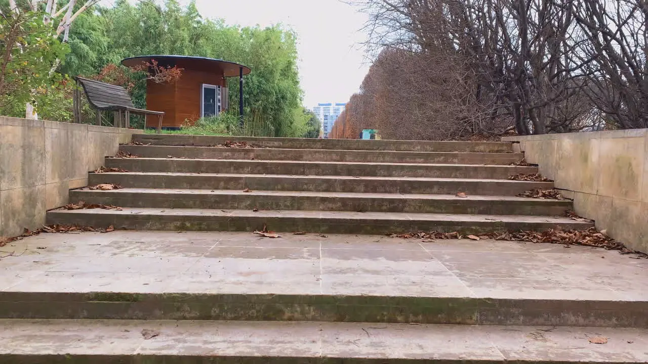 Peeking behind stairs in public park in Paris France