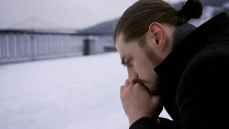 Thoughtful man sitting on a bench