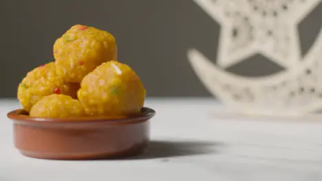 Laddoo In Bowl Celebrating Muslim Festival Of Eid With Symbol Of Pakistan