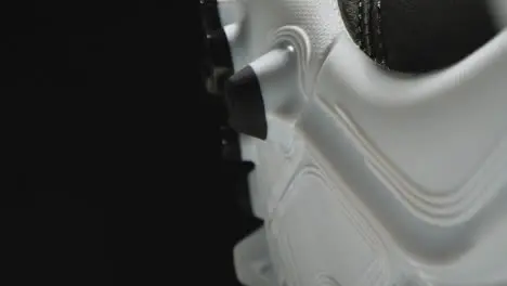 Studio Still Life Close Up Shot Of Football Soccer Boot With Studs Against Black Background 2