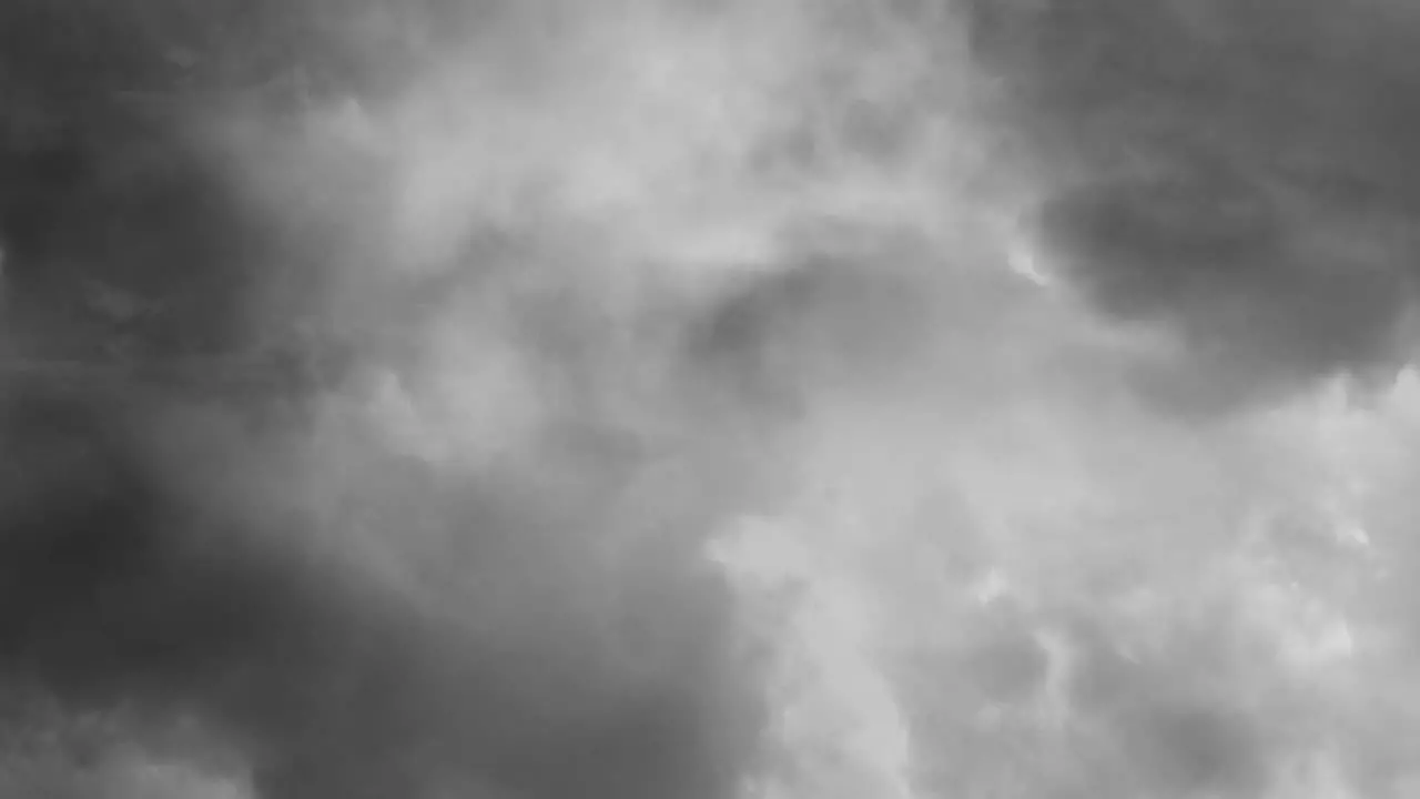 view of a thunderstorm in gray cumulonimbus clouds