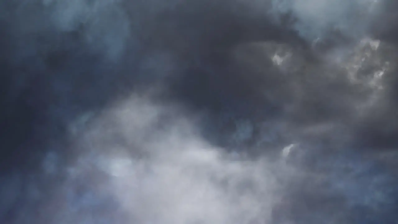 view of thunderstorm inside dark clouds moving in the dark sky