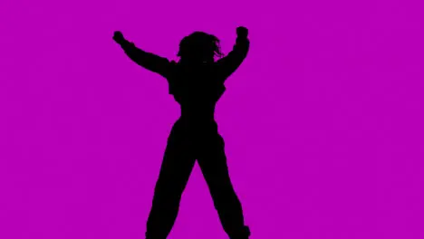 Studio Silhouette Of Woman Dancing Against Purple Background