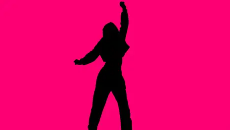 Studio Silhouette Of Woman Dancing Against Pink Background