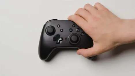 Overhead Hand Reaching In To Pick Up Video Game Controller 10