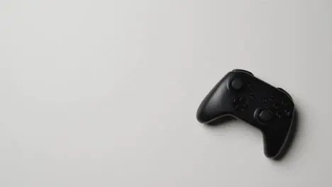 Overhead Studio Shot Of Hand Reaching To Pick Up Video Game Controller 1