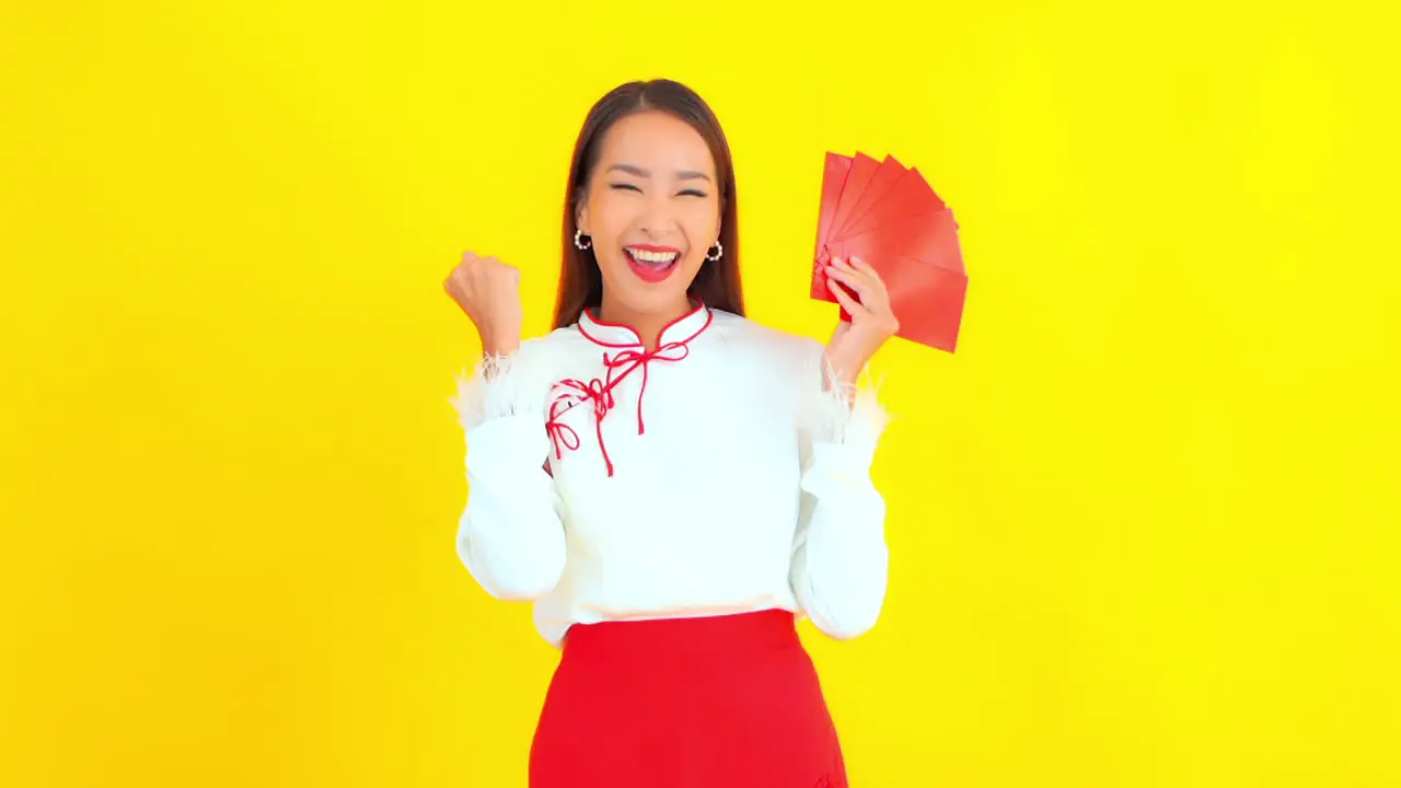 Happy Cheering Woman Holding Blank Red Cards in Hand Yellow Backdrop