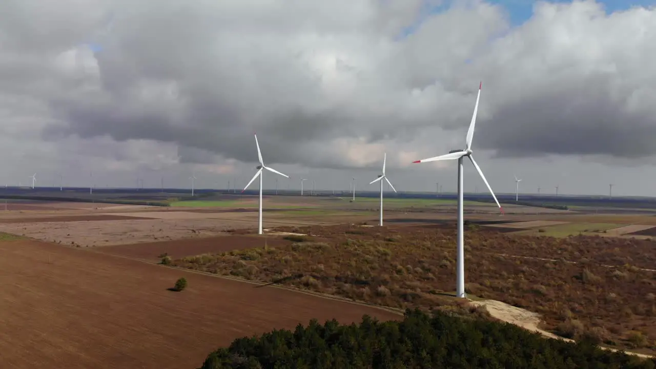 Right side drone flight around running wind turbines