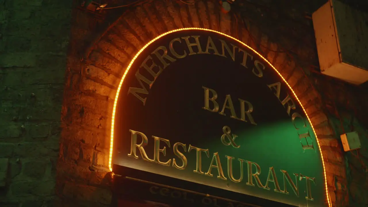 Glowing entrance sign of Marchants Arch Bar and Restauarant in the night