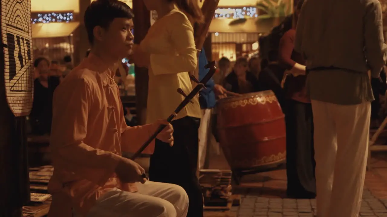 Adult Male Playing Traditional Vietnamese Music on the Street