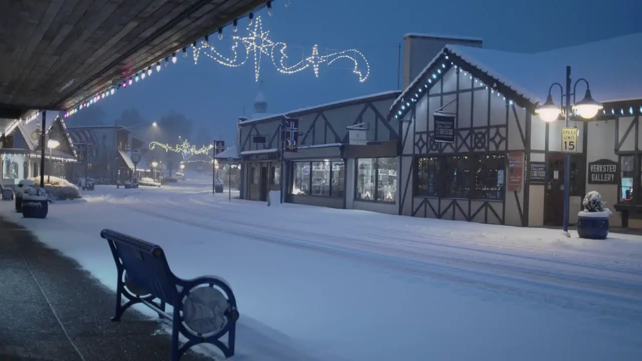 Early morning in Poulsbo Washington with a rare snowfall a view of downtown and a bench