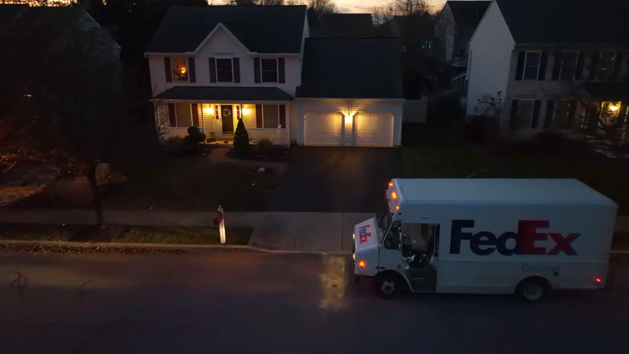 FedEx delivery truck on a residential street at dusk