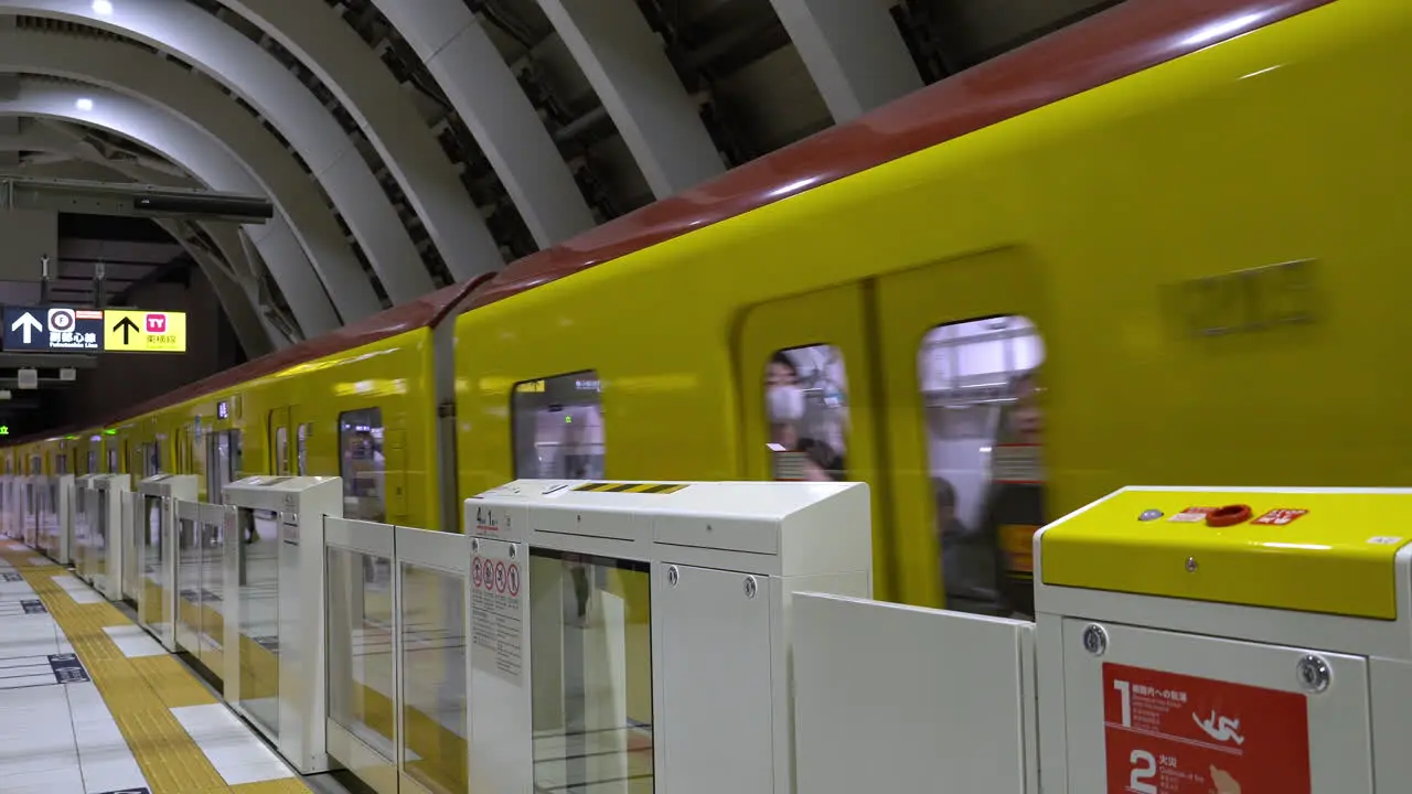 TOKYO JAPAN APRIL 8 2023 Train approaching Tokyo Shibuya station platform with M-shaped white ceiling