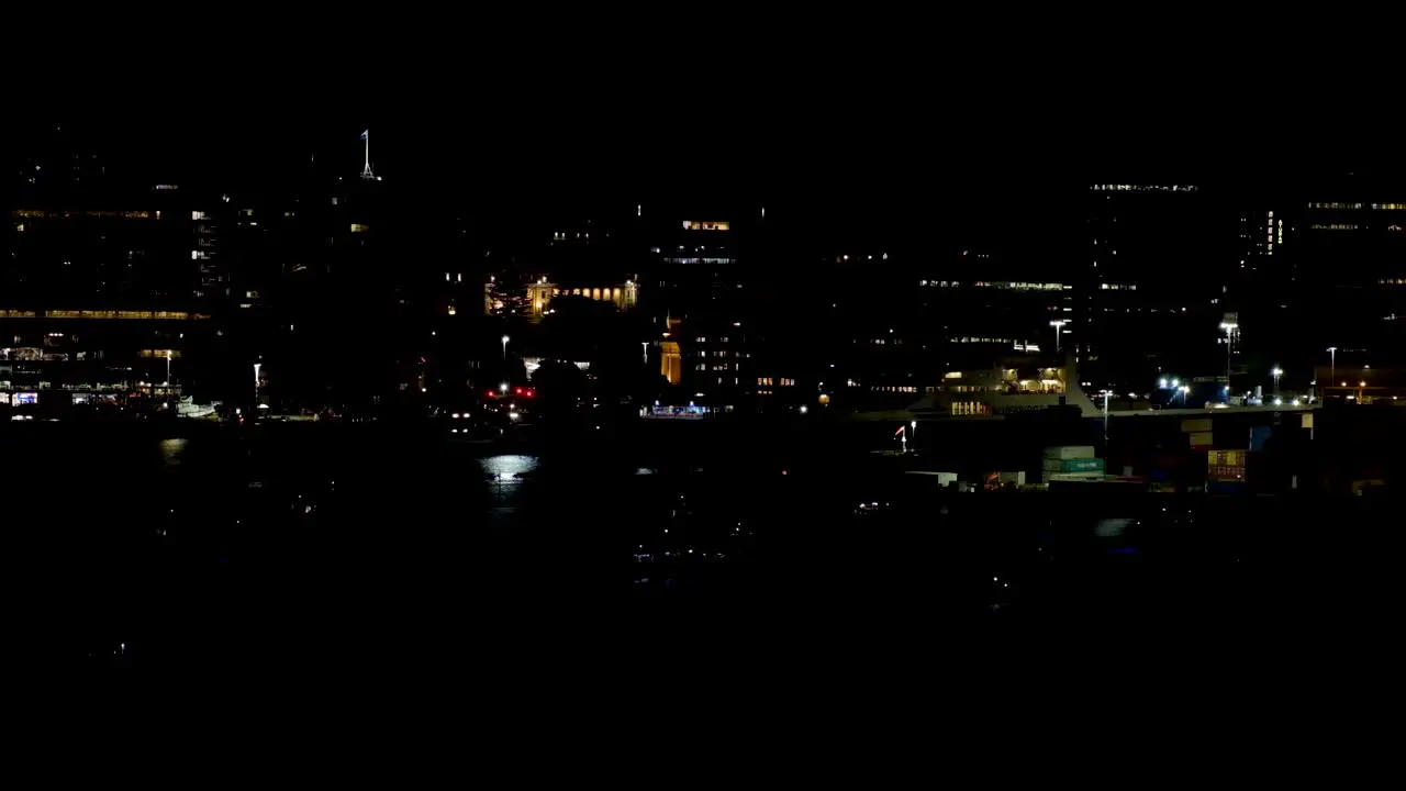 Night time with city building lights in Capital Wellington in New Zealand Aotearoa with lights reflecting over harbour