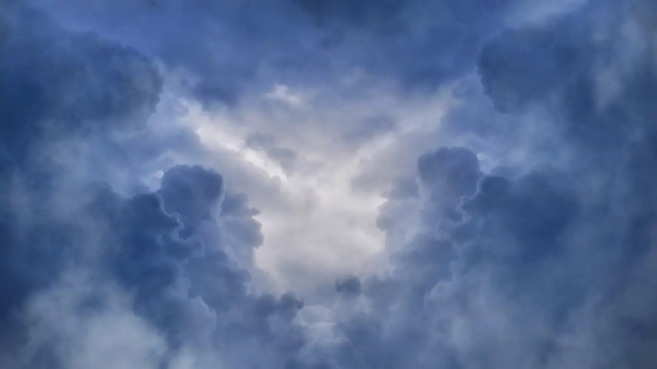 Cumulus clouds were moving closer in the sky with a thunderstorm in them that flashed up