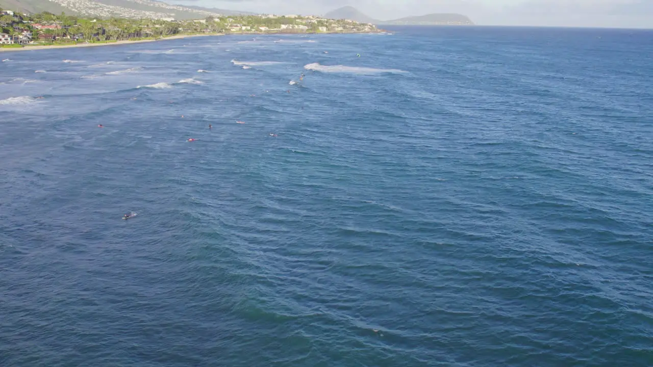 aerial footage of the Pacific ocean along the coast of the island of Oahu as the waves ripple across the surface of the water