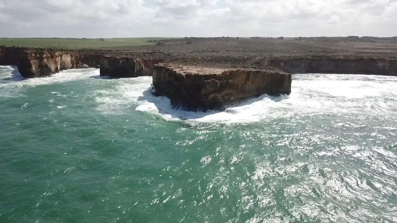 AERIAL RISING REVERSE Waves pounding the eroding Australian coastline