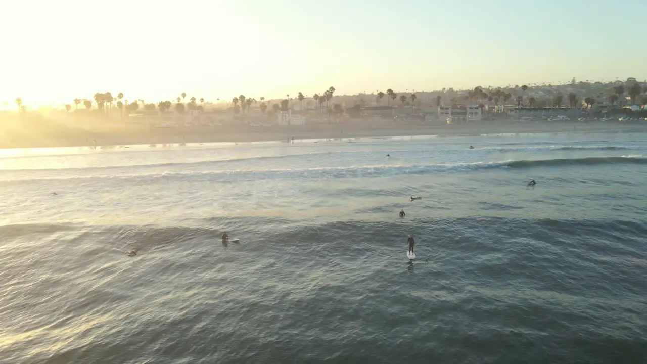 Sunrise Aerial shot circling surfers in Ocean Beach San Diego California