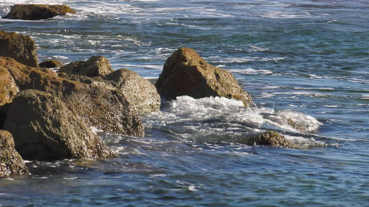 Blue ocean waves crashing on rocks slow motion spain