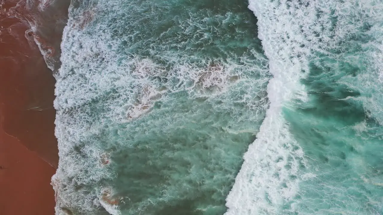 Praia Do Tonel Portugal splashing strong ocean waves Aerial top view shot