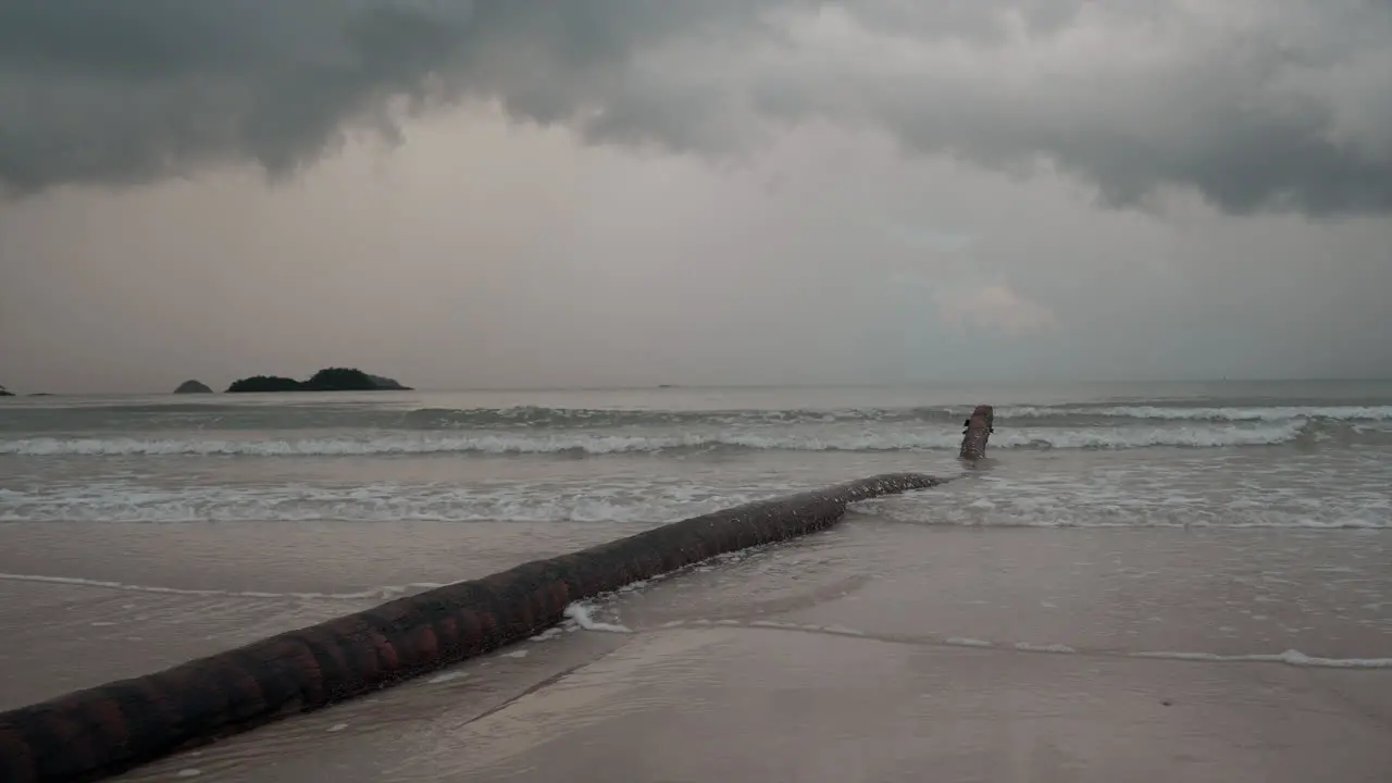 Koh Chang Thailand a tranquil overcast day the camera captures the rhythmic dance of ocean waves rolling onto a picturesque beach