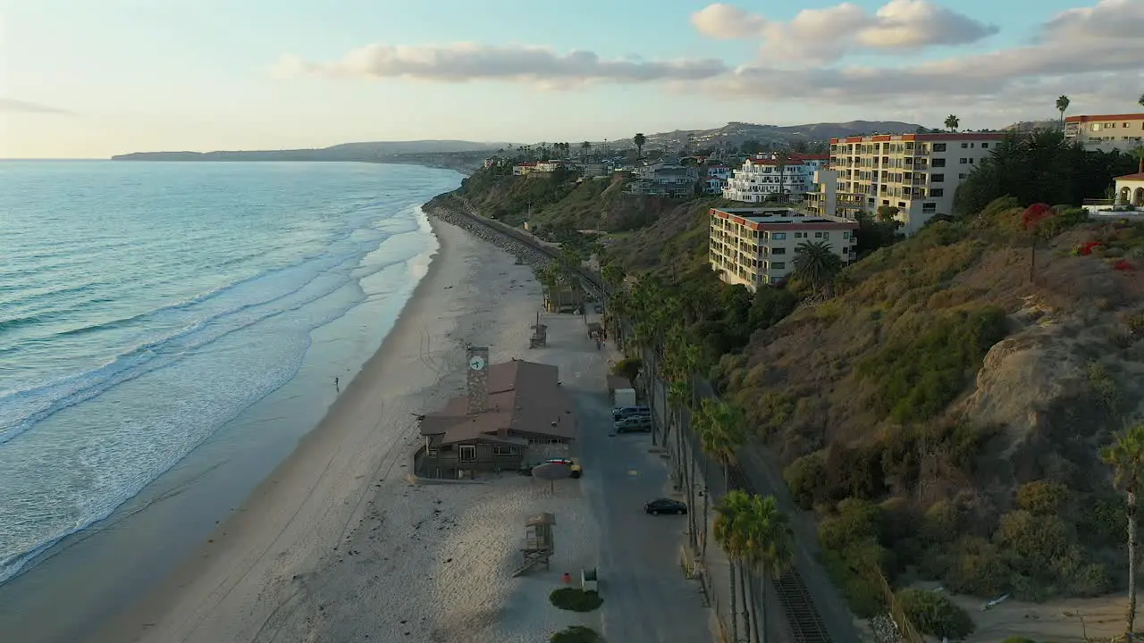 Aerial view over an empty beach in San Clamente California at sundown