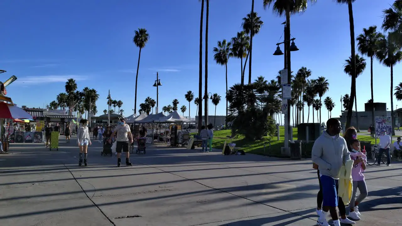 People Walking And Rollerblading At Venice Beach Boardwalk Along Ocean Front Walk In Venice Los Angeles California USA