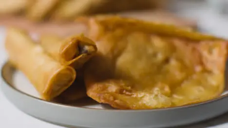 Close Up Of Plate Of Samosas And Glass Of Water On Marble Surface Celebrating Muslim Festival Of Eid 1