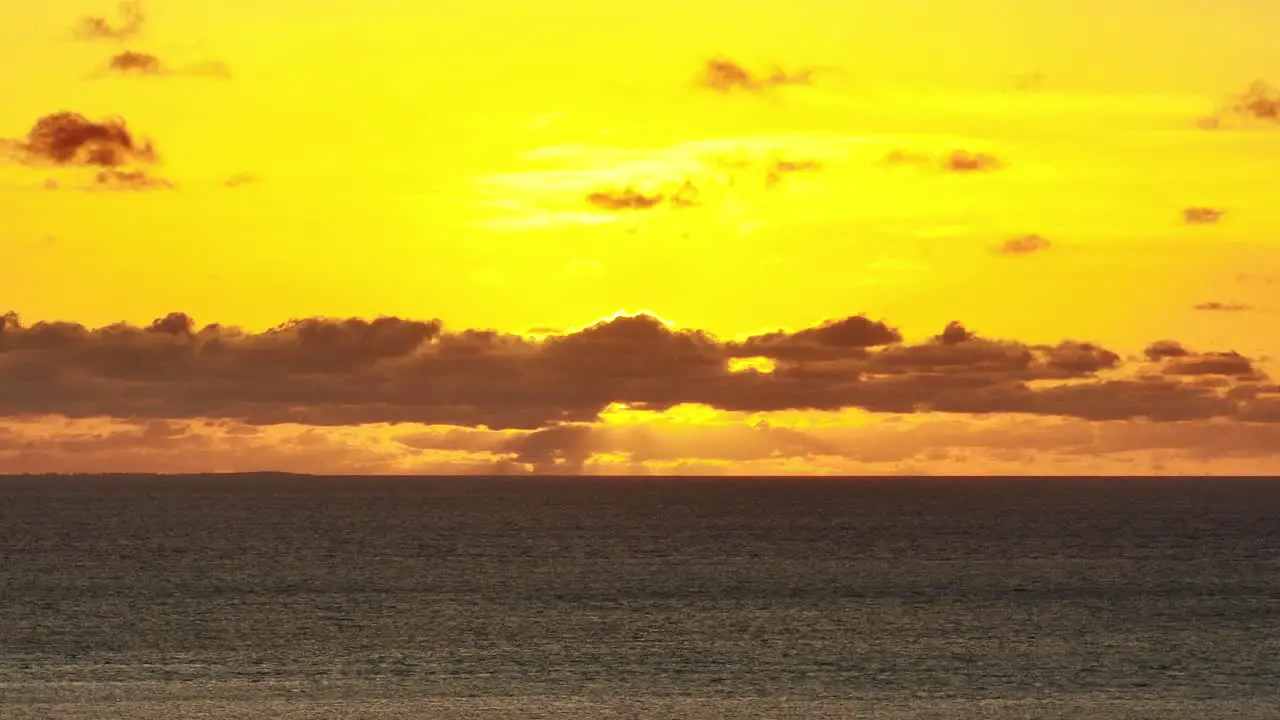 Gorgeous Golden Tropical Sunset With Clouds and Ocean Horizon