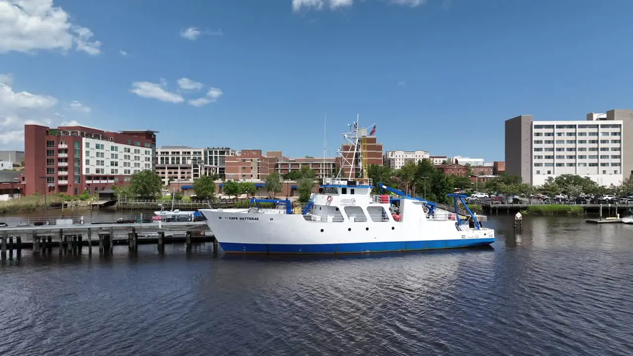 Experience the marvels of marine science with this captivating aerial footage of an ocean research ship gracefully navigating a tranquil river