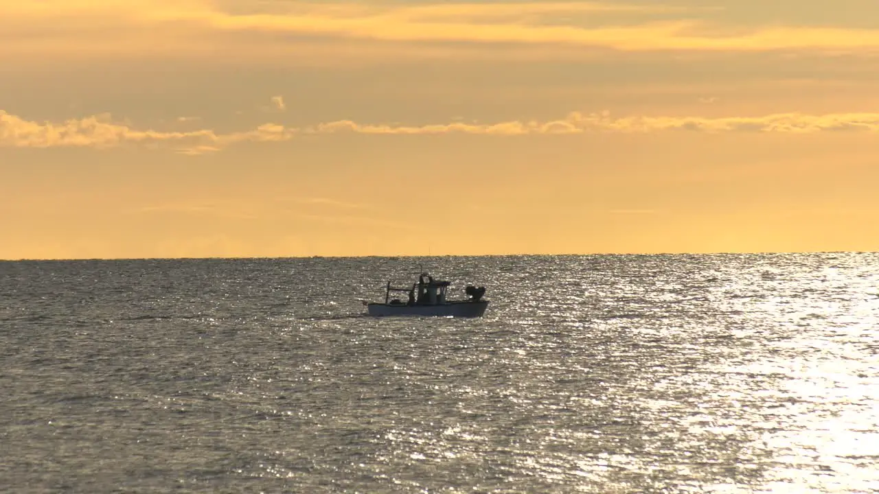 Small Spanish fishing boats on a silver sea at dawn Mediterranean