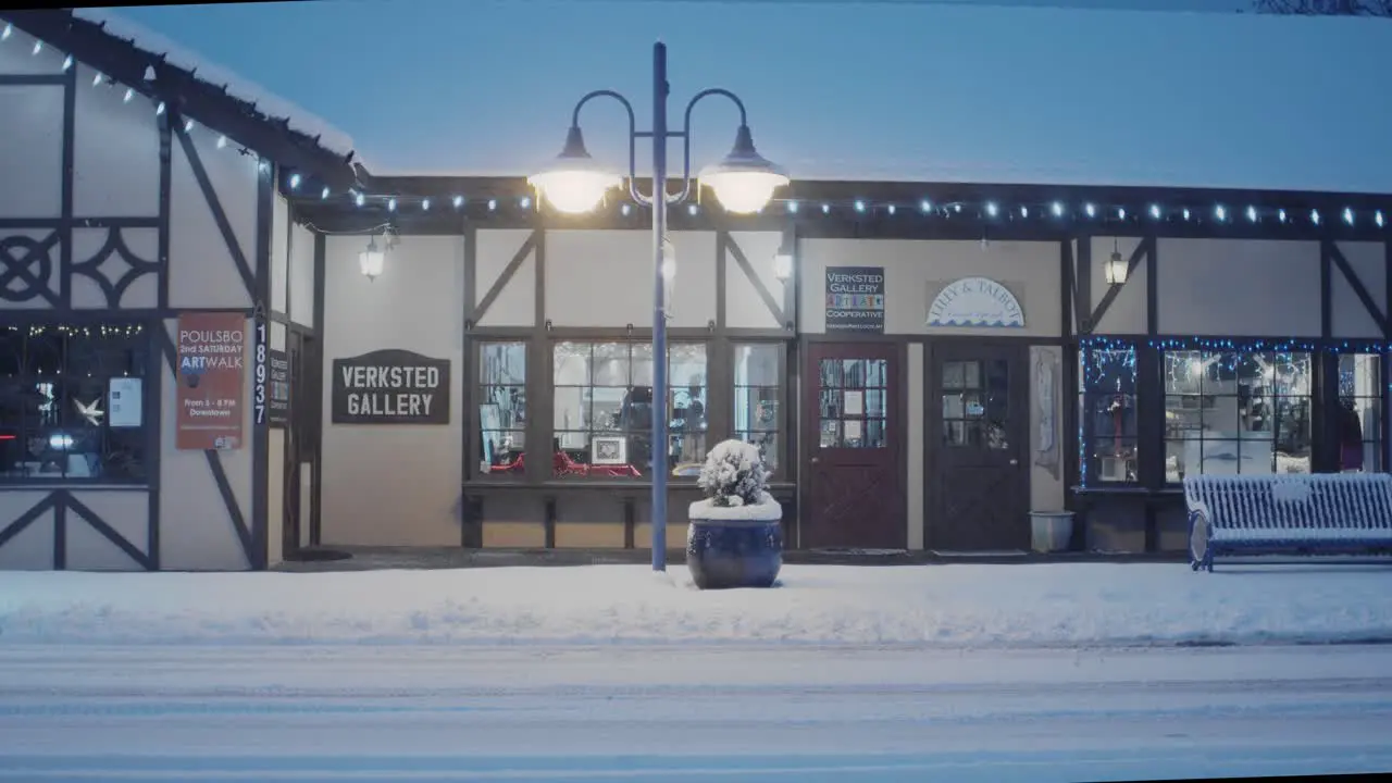 Early morning in Poulsbo Washington with a rare snowfall a view of Verksted Gallery with a snow plow