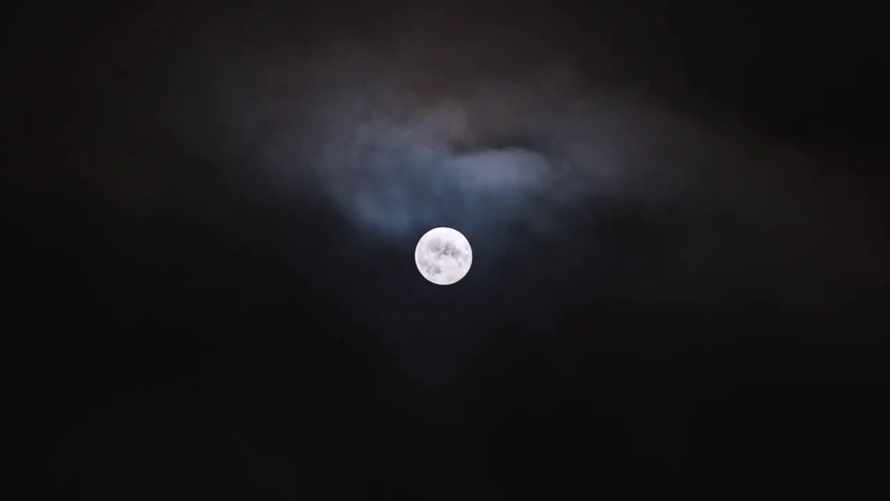 The super moon plays peekaboo with the moody clouds in this sped up video of drama in the sky