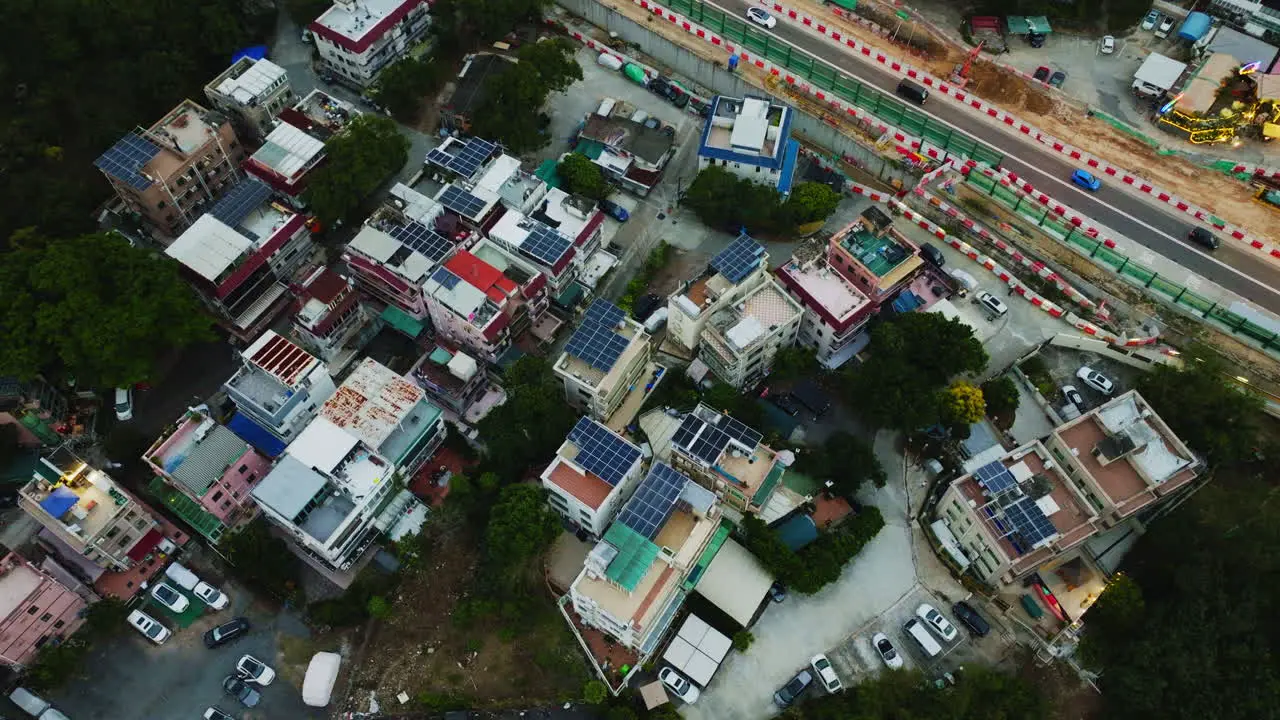 Rotating birds eye view of a local group of houses next to a road