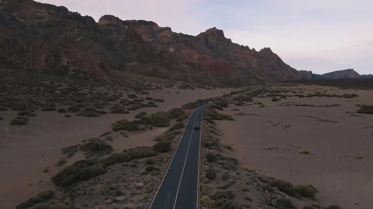 Beautiful Tracking Drone Shot of Mountains and Blue Van Driving Down Highway Tenerife Spain