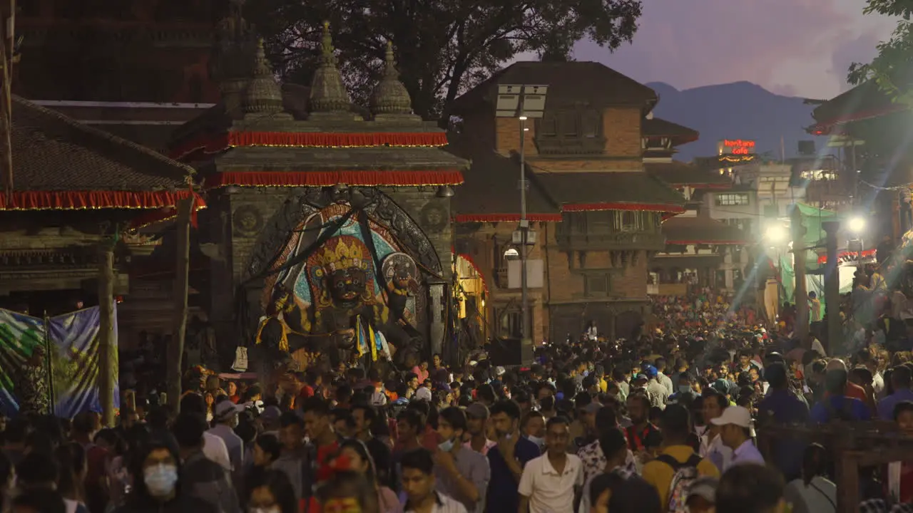 Crowd at Basantaur Durbar Square at night landscape Hills trees and temples rush people everyday lives of Kathmandu drone shot 4K