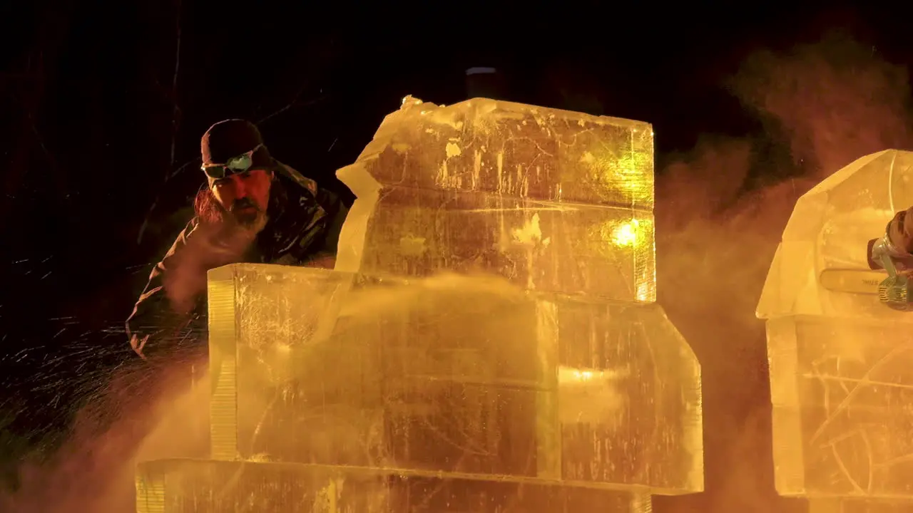 Ice sculptor crafting ice sculptures under night lights