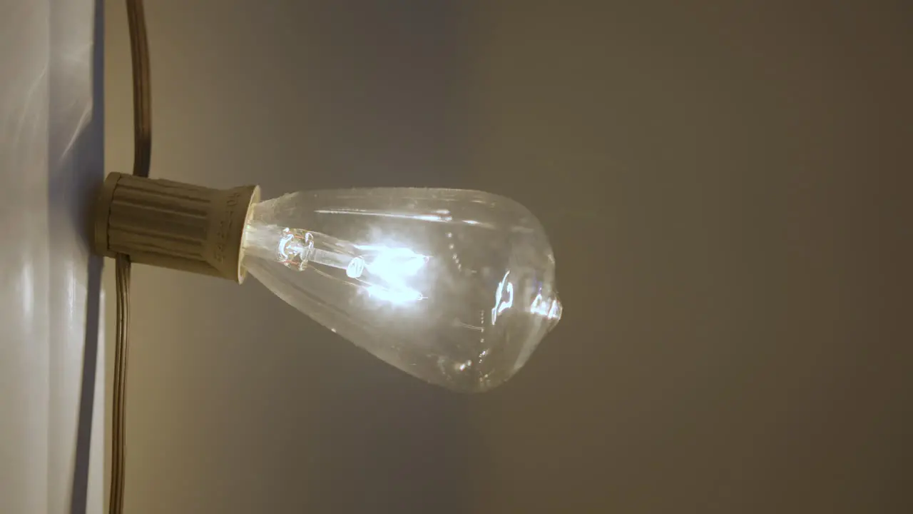 LIghtbulb on a strand flickers on and off with power outage