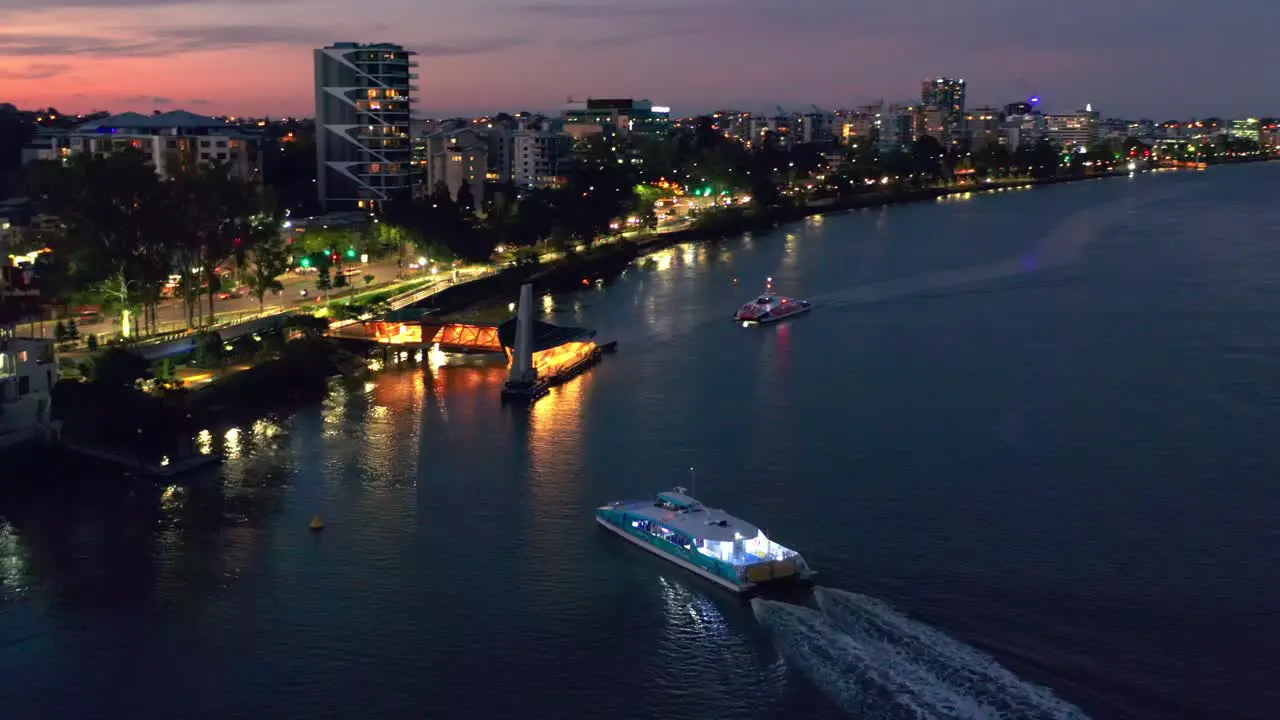 Aerial view of Brisbane City Ferry boat Arriving at "Regatta" terminal in Toowong after sunset