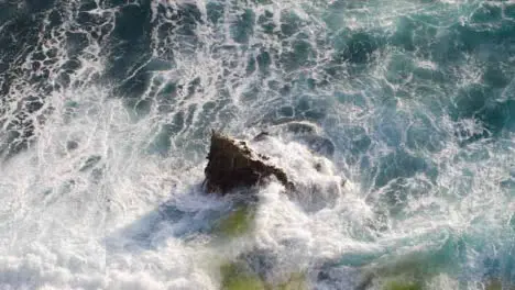 High Angle Shot of Waves Crashing Against Rock On Uluwatu Coast