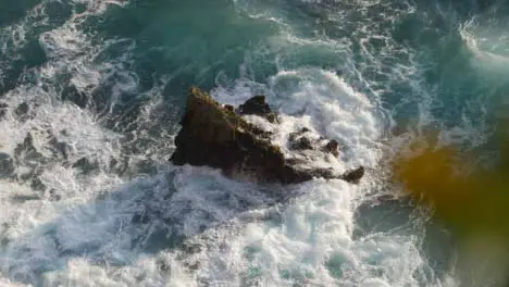 High Angle Shot of Waves Crashing Against Rock On the Uluwatu Coast