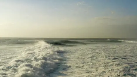 Drone Shot Flying Low Over Waves at Shore of Uluwatu 