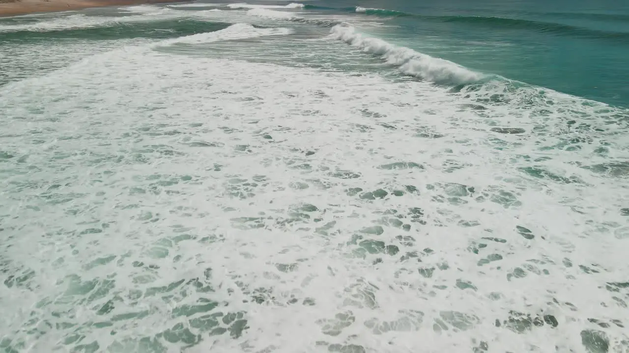 Flying over waves of Hot Water Beach