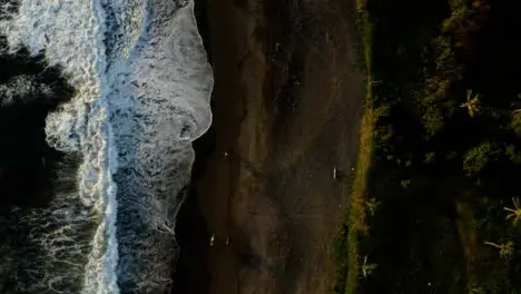 Drone Shot Descending On Waves at Black Sand Pigstone Beach