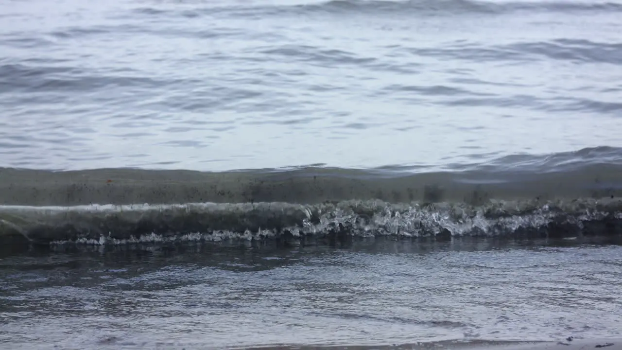 A wave slowly coming in to shore on the lakefront